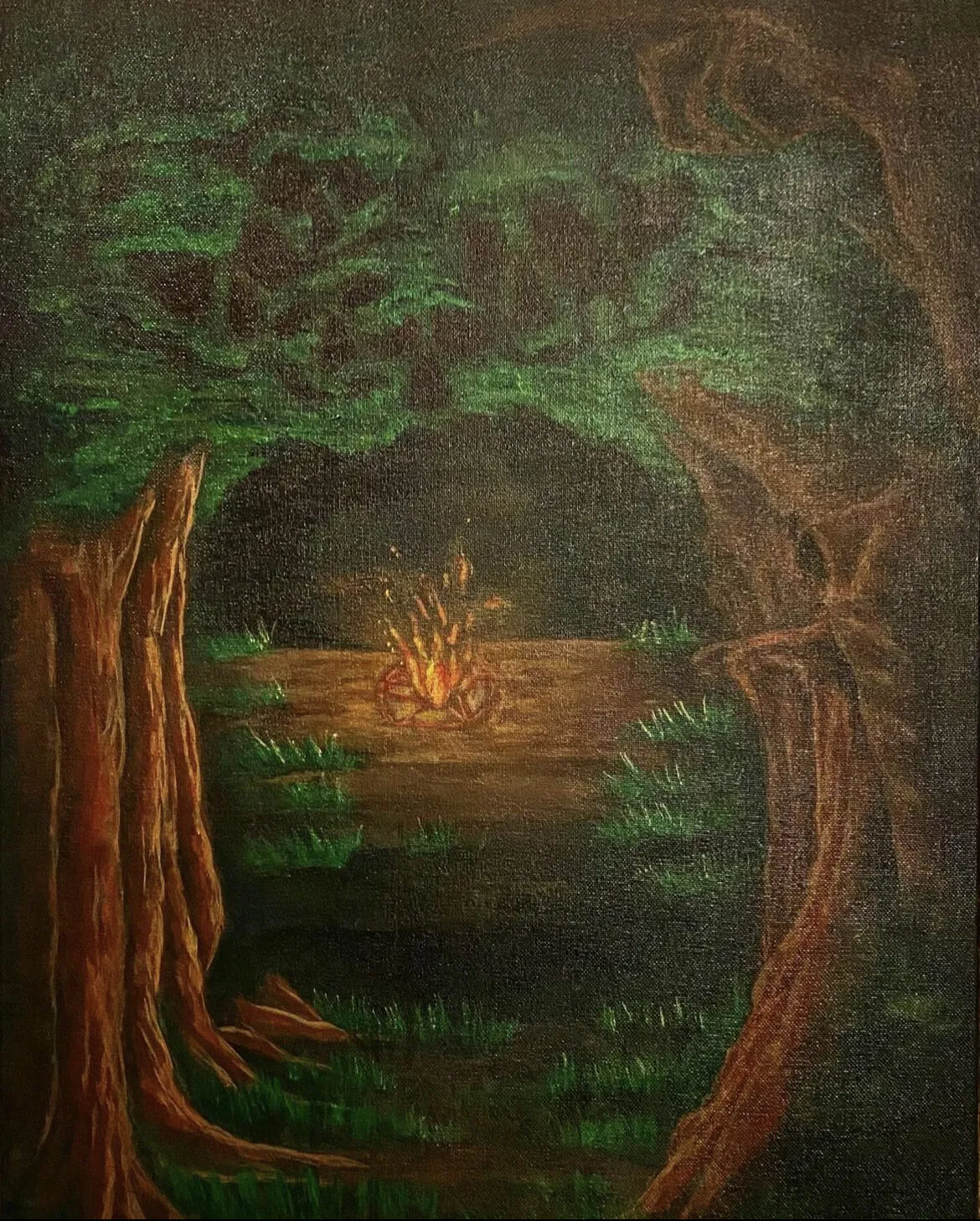 A small fire among dark trees